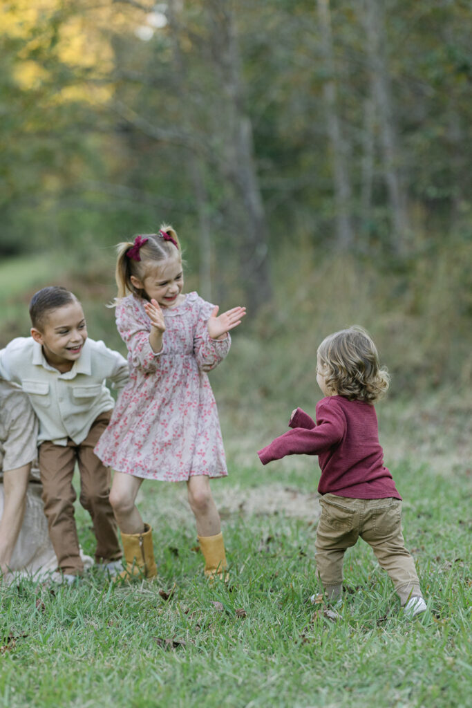 young kids playing with each other during a family session in east texas