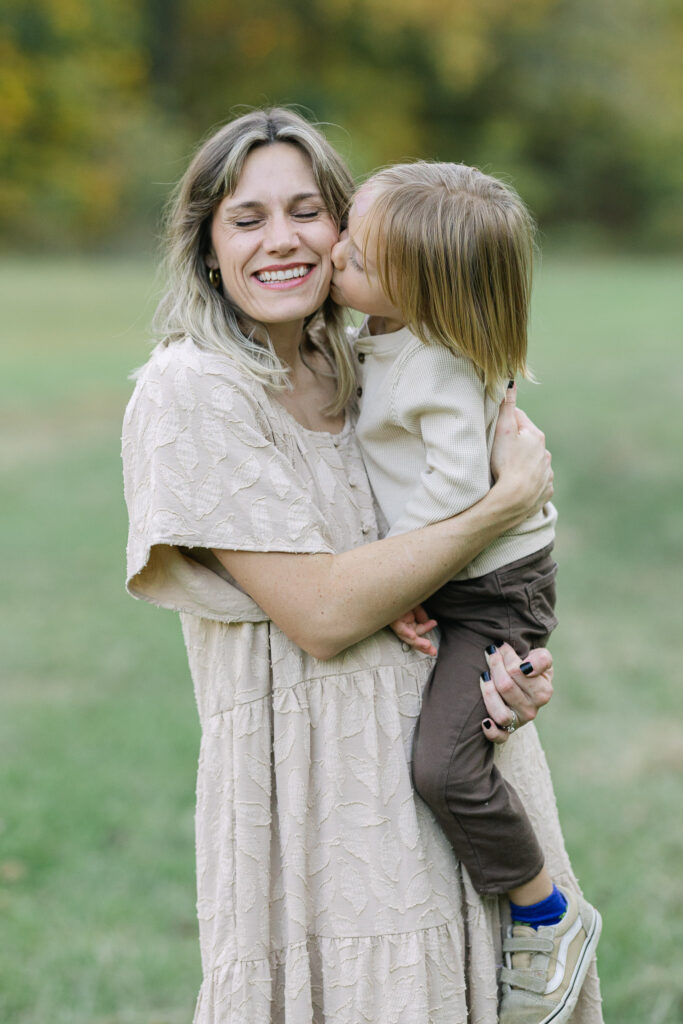 Mom hugging her son tightly during golden hour in East Texas