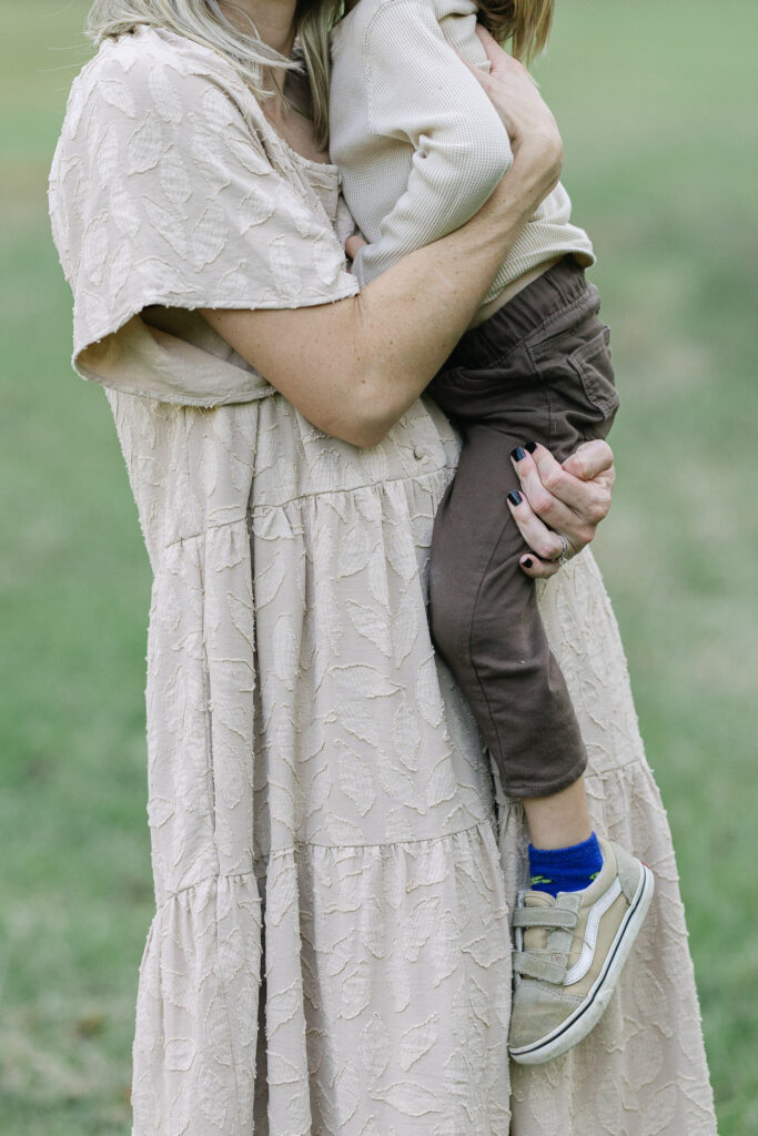Close-up of mom holding her son during outdoor family photos