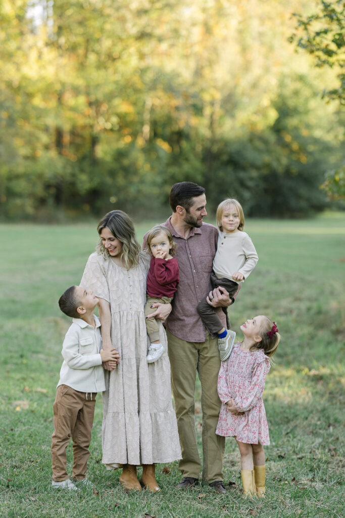 East Texas family standing in an open field at sunset