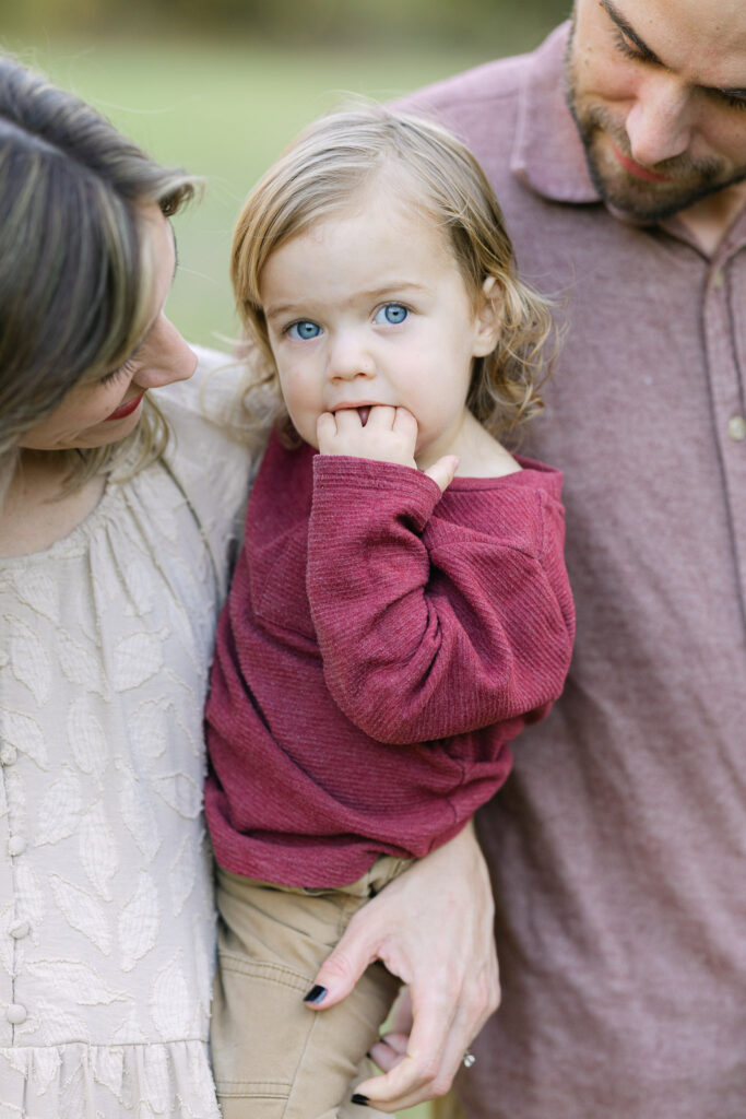 Mom and dad holding their kids during fall family photos