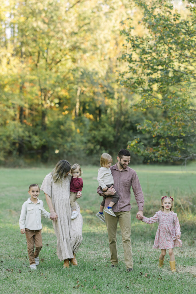 Family walking through tall grass in East Texas