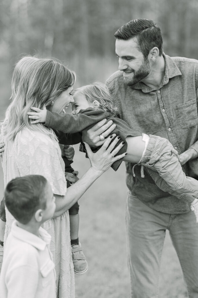 Family gathered close under tall East Texas trees
